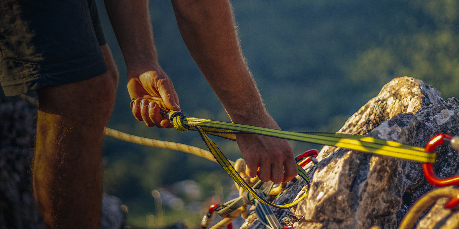 A man sets up a climbing anchor